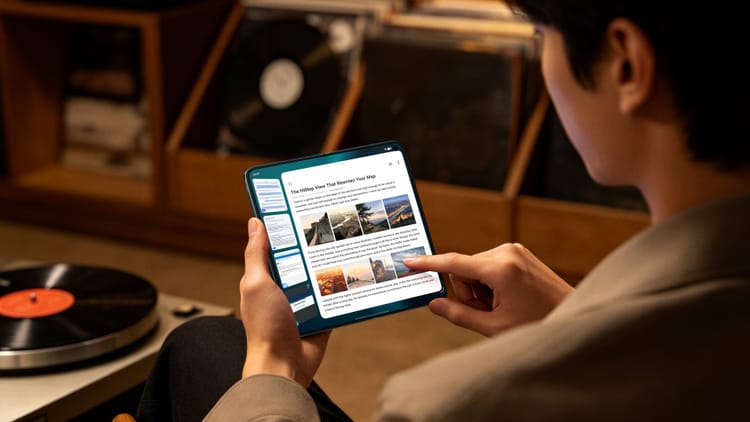 Person using the vivo X Fold6 foldable phone opened like a small tablet